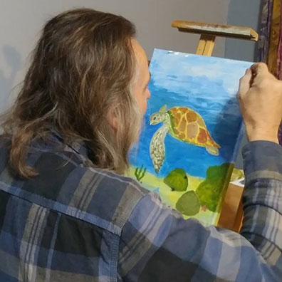 student painting turtle