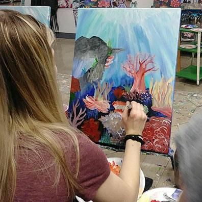 student painting coral
